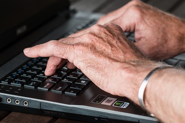 Old person using a laptop computer
